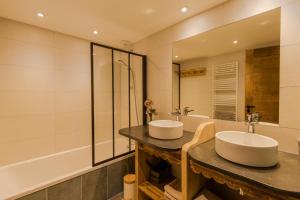 Chez L'Angèle في لي جيه: حمام به مغسلتين وحوض استحمام