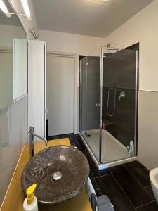 a bathroom with a stone sink and a shower at Fiore di Mantova - casa appartamento vacanze in Virgilio