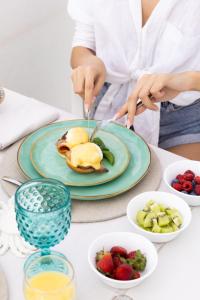 a person cutting a plate of food on a table at Dimora Talenti in Polignano a Mare