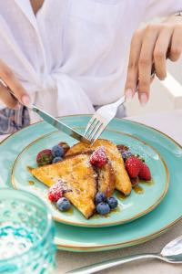 a person cutting a plate of food with a fork and knife at Dimora Talenti in Polignano a Mare