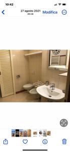 a bathroom with two sinks and two toilets at Domus Orvieto in Orvieto