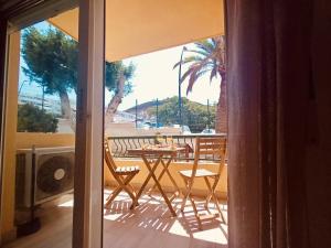a patio with a table and chairs on a balcony at On the Beach Holiday Home in Los Cristianos