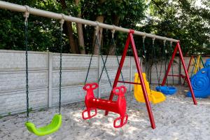 a group of swings in a playground at Perła Bałtyku in Pustkowo +23 photos