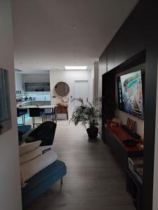 ein Wohnzimmer mit einem Sofa und einem Esszimmer in der Unterkunft Appartement au Grau du roi in Le Grau-du-Roi