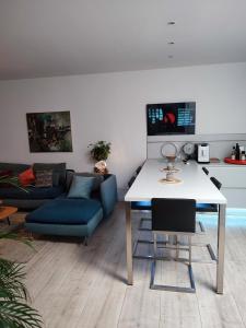 a living room with a table and a couch at Appartement au Grau du roi in Le Grau-du-Roi +9 photos