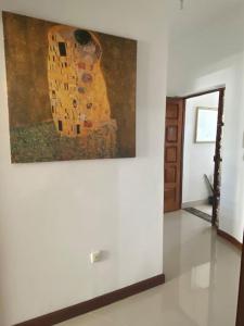 a painting of a woman on a wall in a room at Apartamento Siomaly - Piscina in Praia