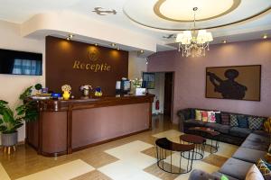 a hotel lobby with a reception desk and a bar at Hotel Stefani in Sibiu