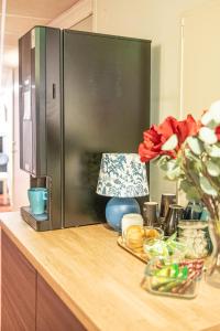 a kitchen counter with a refrigerator on top of it at Hotel Kupolen in Borlänge