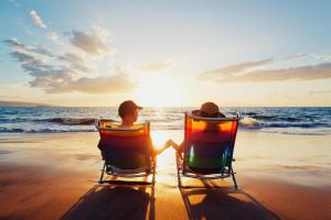 two people sitting in chairs on the beach watching the ocean at Lovely Caravan With Decking At North Denes Park In Suffolk, Ref 40050nd in Lowestoft