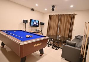 a living room with a pool table and a couch at Pool Villa at Salak 