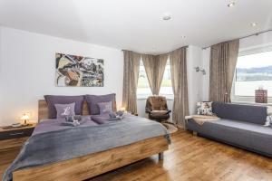 a bedroom with a large bed and a couch at Ferienwohnung Katharina in Hollersbach im Pinzgau