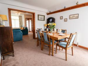 a dining room with a wooden table and chairs at 91 Main Street in Frodsham