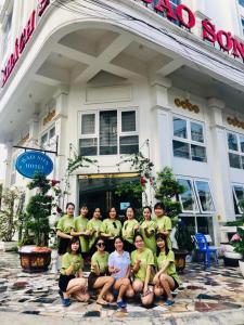 a group of people posing in front of a building at Bảo Sơn Hotel in Ha Long