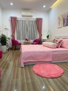 a bedroom with a pink bed and a pink rug at Nhà Nghỉ Huyền Anh in Hanoi