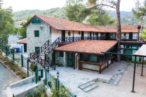 a house with a red roof and a staircase at Pine View Hotel (Okella) in Saittas