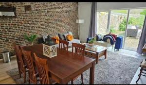 a living room with a wooden table and a couch at Hoeve op de Meer in Maastricht