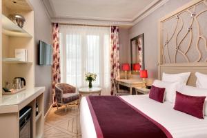 a hotel room with a large bed and a desk at Rochester Champs Elysees in Paris +61 photos