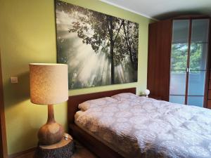 - une chambre avec un lit et une grande peinture murale dans l'établissement Apartement Wald-Panorama Fuchsenstein, à Spiegelau
