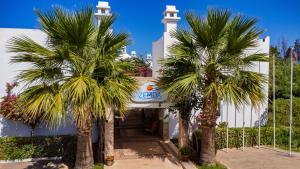 a church with palm trees in front of it at Ladonia Hotels Zemda Boutique in Gumusluk