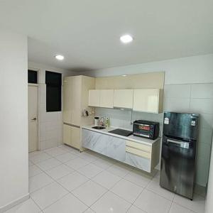 a kitchen with a stainless steel refrigerator and white cabinets at Cozy Sky Loft 5 Guests with Netflix & Facilities L28 in Johor Bahru