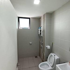 a bathroom with a shower with a toilet and a sink at Cozy Sky Loft 5 Guests with Netflix & Facilities L28 in Johor Bahru