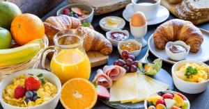 a bunch of breakfast foods on a table at Hotel Biesbosch in Drimmelen