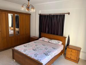 a bedroom with a bed and a dresser and a window at Palm Villa in Kyrenia