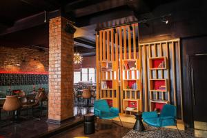 a room with chairs and tables and a brick wall at Revolver in Glasgow