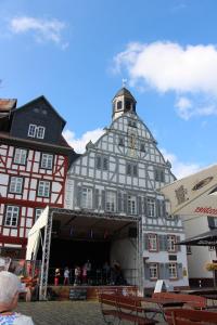 a building with a clock tower on top of it at Wohnung-Aublick in Butzbach