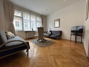 a living room with a couch and a piano at Old Town Residence - Konviktská in Prague