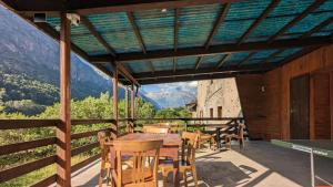 a table and chairs on a balcony with a view at Gîte Loubet in Saint-Jacques-en-Valgodemard