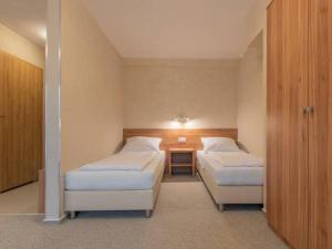 a hotel room with two beds and a table at OSCAR Obiekt Noclegowy in Sandomierz