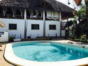a swimming pool in front of a villa at Casa Bella 4 Bedroom Villa in Watamu