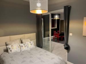 a bedroom with a bed and a room with a table at Destination Confidentielle in Clermont-Ferrand