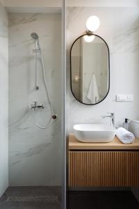 a bathroom with a sink and a mirror at Smaragd Residence Zagreb Downtown in Zagreb