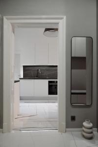 a kitchen with white cabinets and a sink at Smaragd Residence Zagreb Downtown in Zagreb