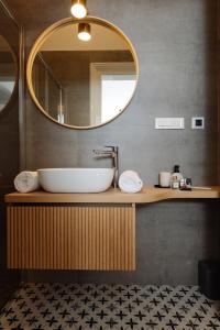 a bathroom with a sink and a mirror at Smaragd Residence Zagreb Downtown in Zagreb