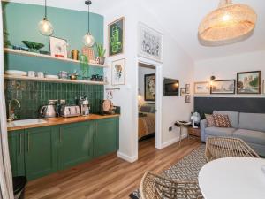 a living room with green cabinets and a couch at The Lodge in York