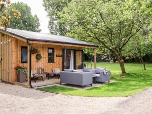 a wooden cabin with couches and a patio at The Lodge in York