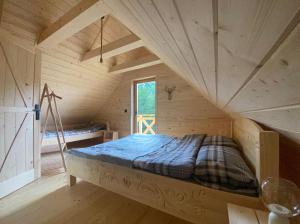 a bed in the middle of a room at Babiogórskie klimaty in Zawoja