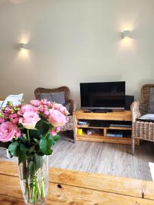 a living room with a vase of flowers on a table at Winterberg Appartement 21097 in Winterberg