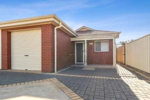 a red brick house with a garage at The Shamrock House in Renmark