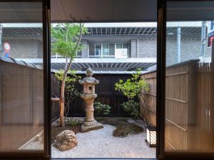 a garden with a fire hydrant in the yard at Tabist kiki HOTEL KYOTO Gojo Karasuma in Kyoto