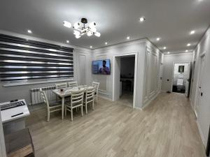 a kitchen and dining room with a table and chairs at Entire Apartment in Central Nukus in Nukus