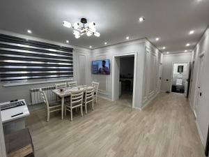a kitchen and dining room with a table and chairs at Entire Apartment in Central Nukus in Nukus +11 photos