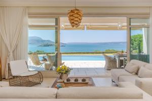 a living room with a view of the ocean at SK Place Luxury Seafront Villas Chania in Almyrida