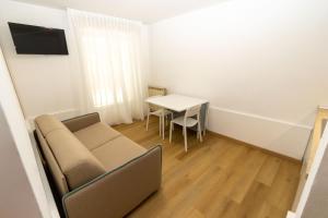 a living room with a couch and a table at DimmiDiRimini - Appartamenti in Affitto in Rimini