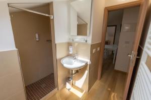 a bathroom with a sink and a shower at DimmiDiRimini - Appartamenti in Affitto in Rimini +45 photos