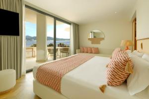 a bedroom with a bed and a view of the ocean at TRS Ibiza Hotel - Adults Only in San Antonio