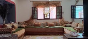 a living room with a couch and a window at Dar Dyafa in Salé